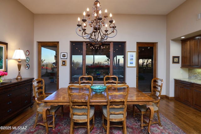 dining space featuring an inviting chandelier and dark hardwood / wood-style floors