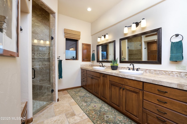 bathroom featuring decorative backsplash, an enclosed shower, and vanity