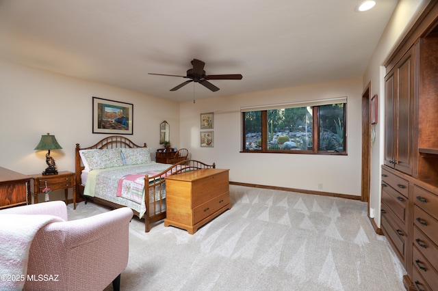 bedroom with ceiling fan and light colored carpet