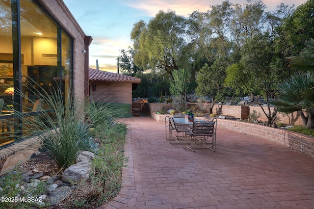 view of patio terrace at dusk