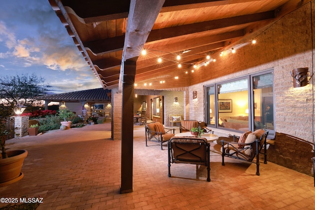 patio terrace at dusk featuring an outdoor hangout area