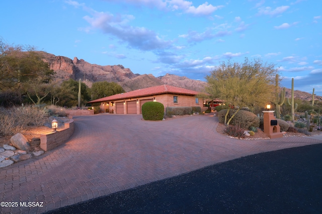 view of front of house with a garage and a mountain view