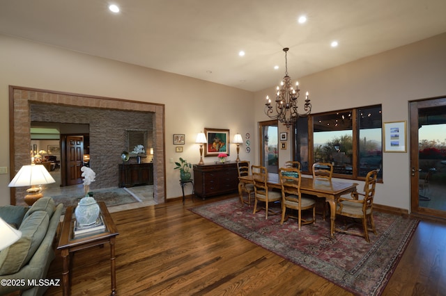 dining room with an inviting chandelier and dark hardwood / wood-style floors