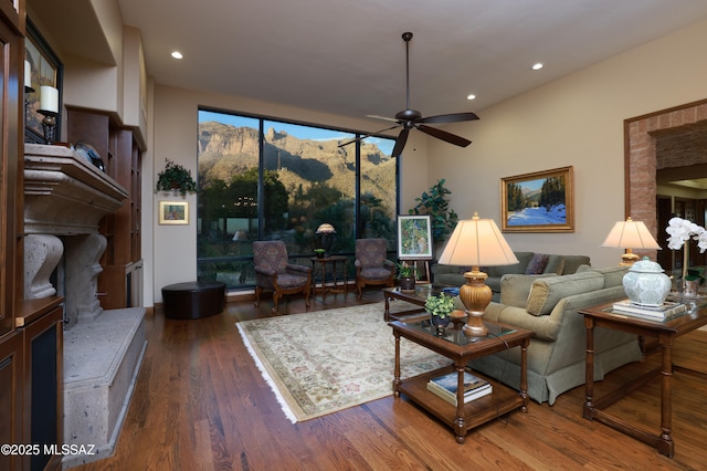 living room featuring ceiling fan and dark hardwood / wood-style flooring