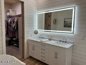 16911 S Joshua Tree Rd, Mayer, AZ 86333 - bathroom with double vanity, wood walls, wood finished floors, and a spacious closet