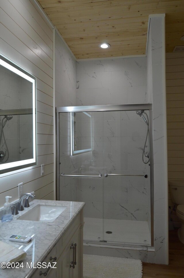 16911 S Joshua Tree Rd, Mayer, AZ 86333 - bathroom featuring vanity, wooden ceiling, toilet, a marble finish shower, and wood walls