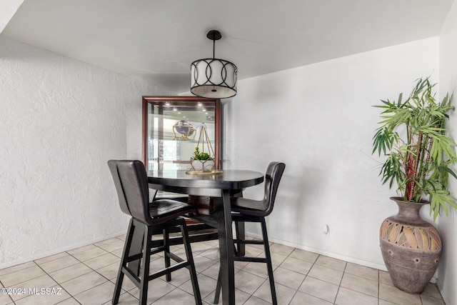 dining area featuring light tile patterned flooring