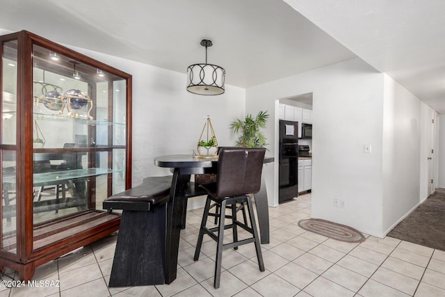 dining space featuring light tile patterned flooring