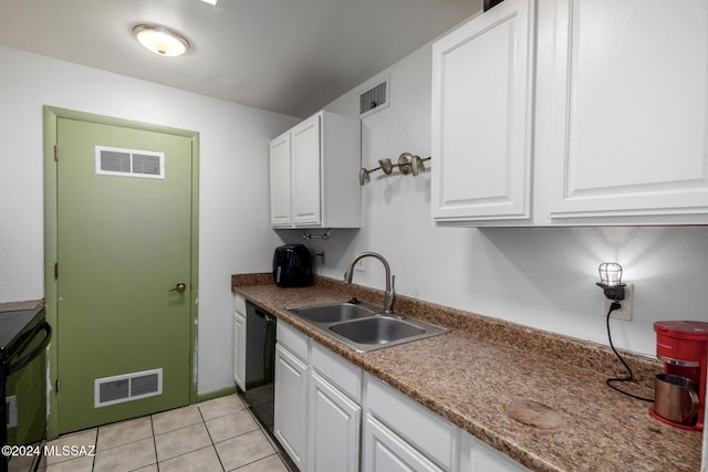 kitchen with dishwasher, light tile patterned flooring, white cabinetry, and sink