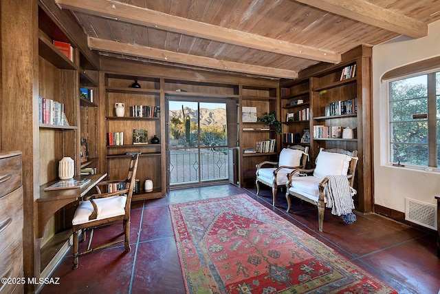 sitting room with dark tile patterned floors, built in features, beam ceiling, and wood ceiling