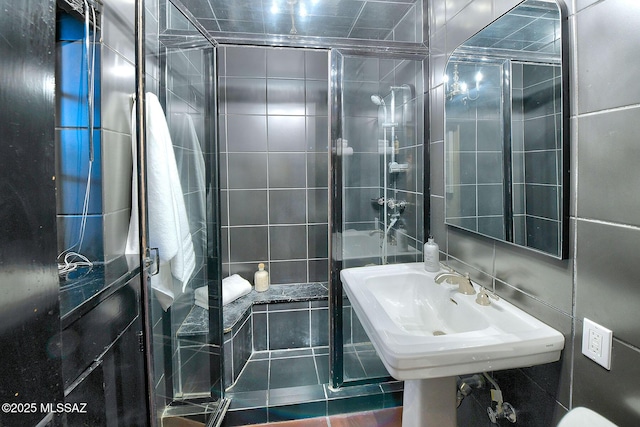 bathroom with sink, tile walls, and tile patterned flooring