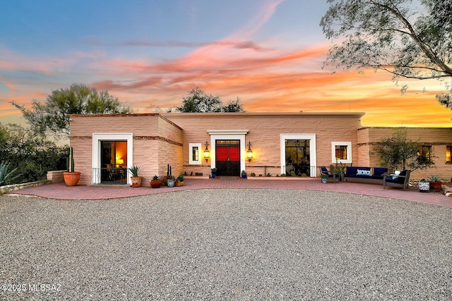 view of front of house featuring a patio and outdoor lounge area