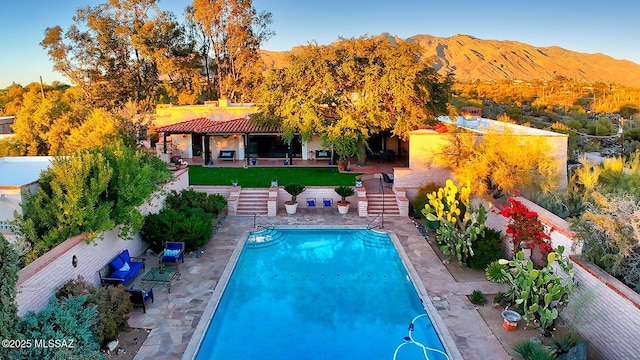 view of pool featuring a mountain view and a patio area