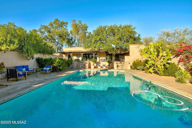 view of pool featuring a patio and outdoor lounge area