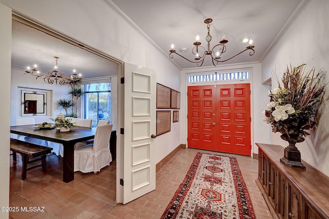 foyer featuring ornamental molding and an inviting chandelier