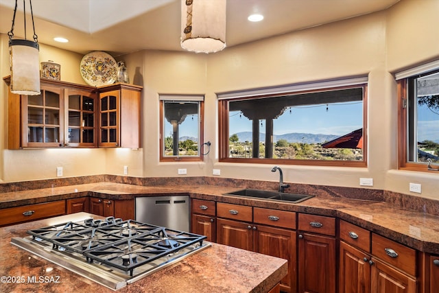 kitchen featuring a mountain view, hanging light fixtures, sink, and appliances with stainless steel finishes