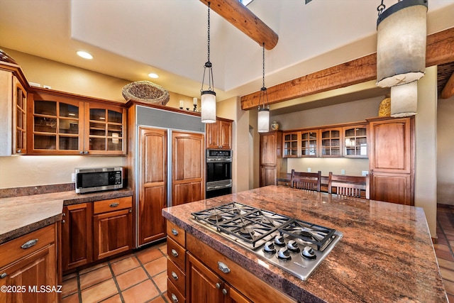 kitchen featuring beamed ceiling, appliances with stainless steel finishes, hanging light fixtures, and light tile patterned flooring