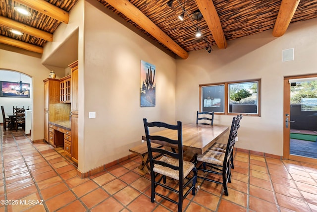 tiled dining area with beam ceiling, high vaulted ceiling, and wooden ceiling