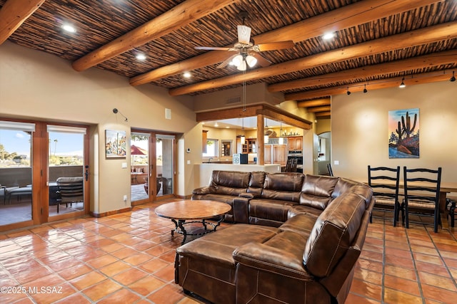 living room with ceiling fan, french doors, beamed ceiling, light tile patterned floors, and wood ceiling