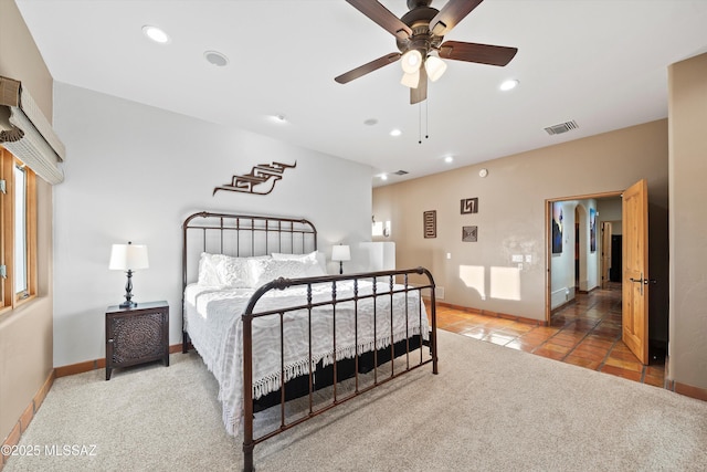 tiled bedroom featuring ceiling fan