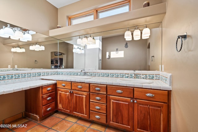 bathroom featuring tile patterned floors, vanity, and backsplash