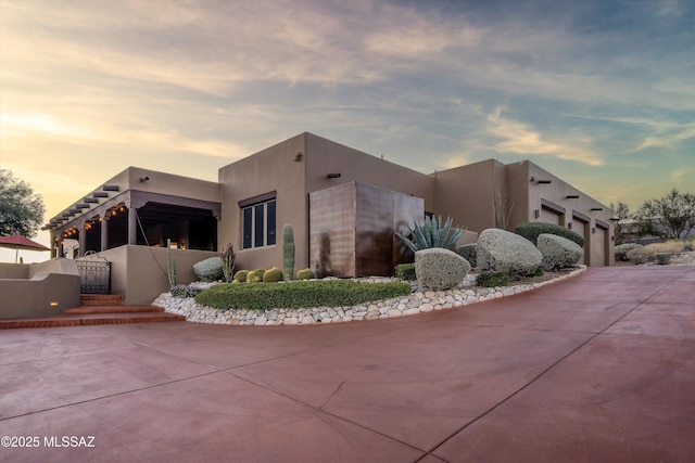 property exterior at dusk featuring a garage