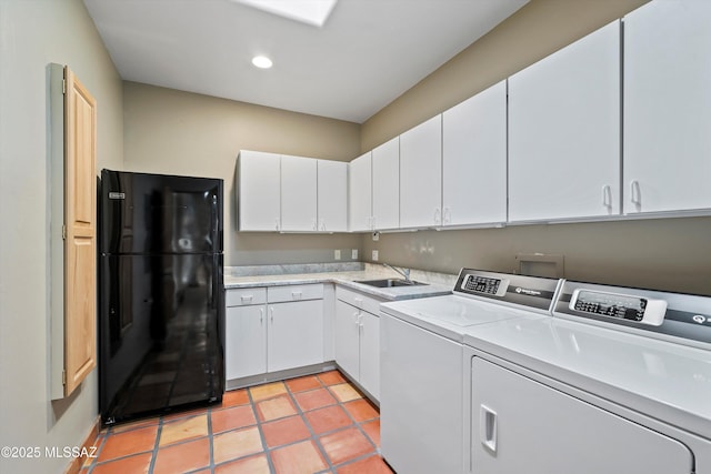 clothes washing area featuring light tile patterned flooring, cabinets, independent washer and dryer, and sink