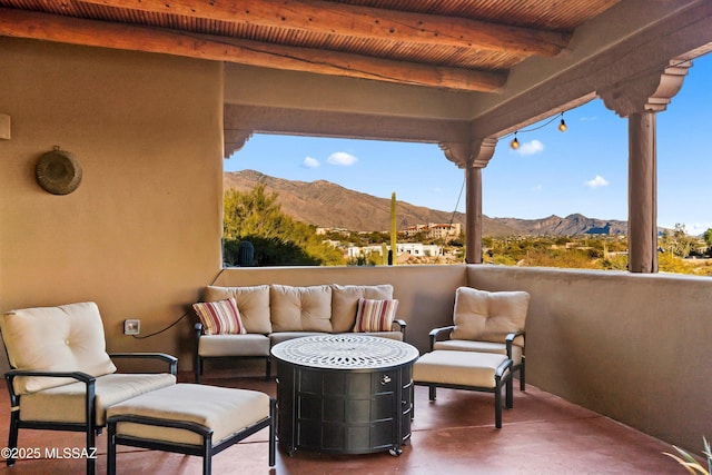 view of patio featuring a mountain view and a balcony