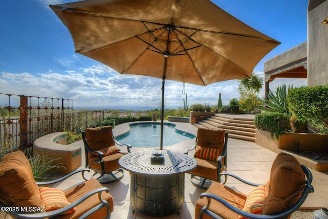 view of swimming pool featuring a patio area