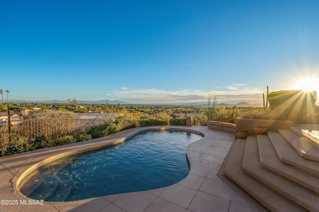 view of pool with a mountain view and a patio area