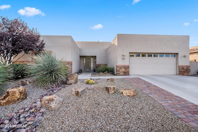 pueblo revival-style home featuring a garage