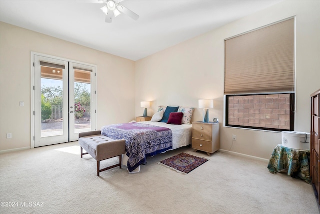 bedroom with access to exterior, ceiling fan, and light colored carpet