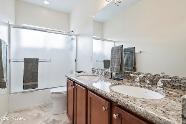 full bathroom with shower / bath combination with glass door, vanity, and toilet