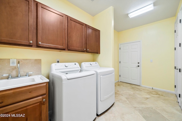 washroom with washer and dryer, cabinets, light tile patterned floors, and sink