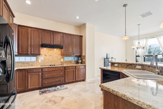 kitchen featuring decorative backsplash, black appliances, sink, a chandelier, and hanging light fixtures