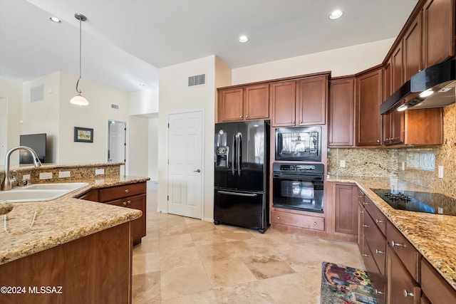 kitchen with black appliances, sink, light stone countertops, and hanging light fixtures