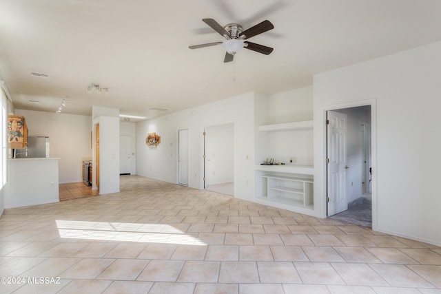 unfurnished living room with light tile patterned floors and ceiling fan