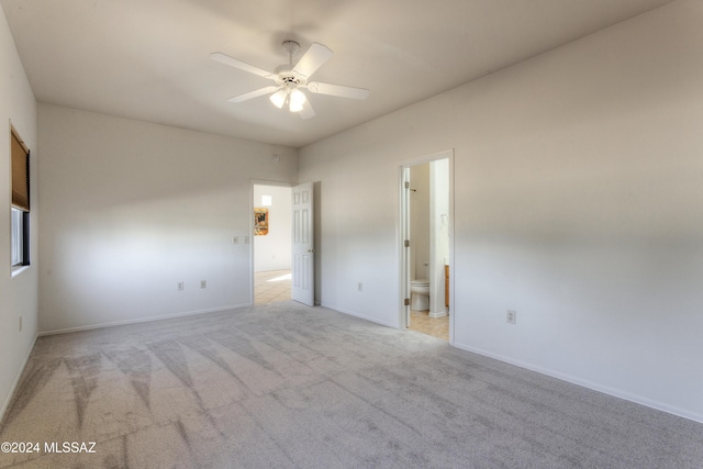 unfurnished room featuring light colored carpet and ceiling fan