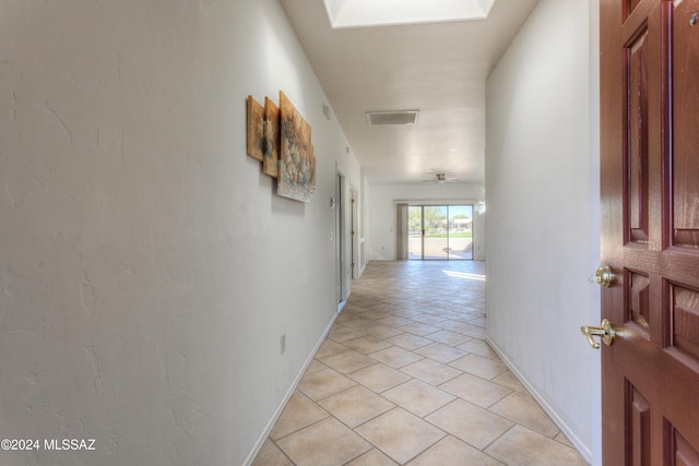 corridor featuring light tile patterned floors