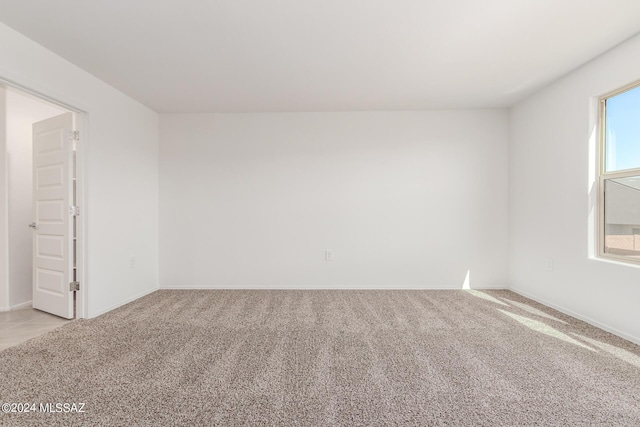 unfurnished room featuring light colored carpet