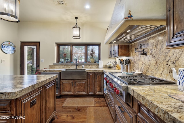 kitchen featuring dark hardwood / wood-style flooring, backsplash, ventilation hood, sink, and pendant lighting