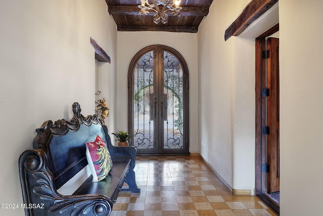 entrance foyer with wooden ceiling, french doors, and a chandelier