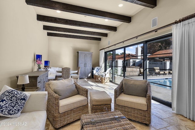 living room featuring beamed ceiling