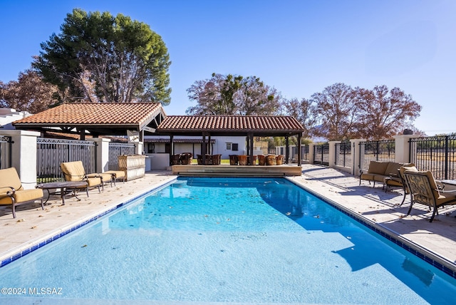 view of swimming pool with a gazebo and a patio