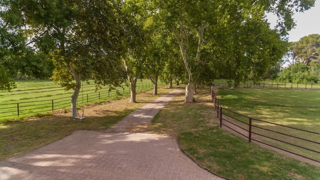 view of property's community with a lawn and a rural view