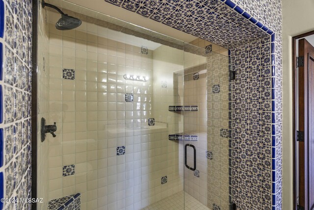 bathroom featuring a shower with door