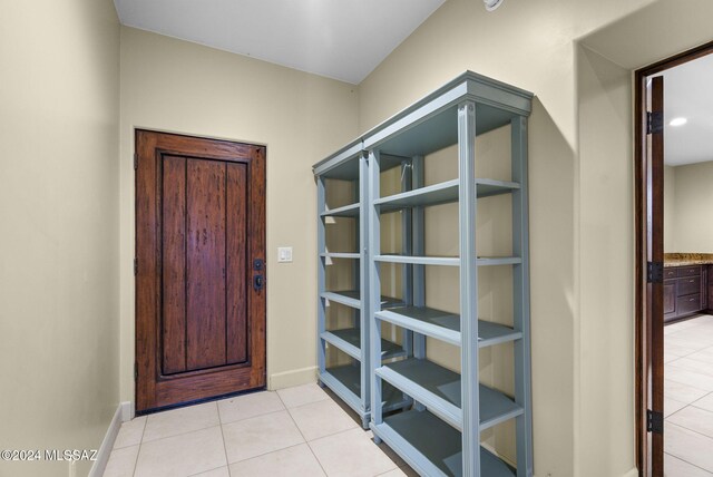 doorway with light tile patterned floors