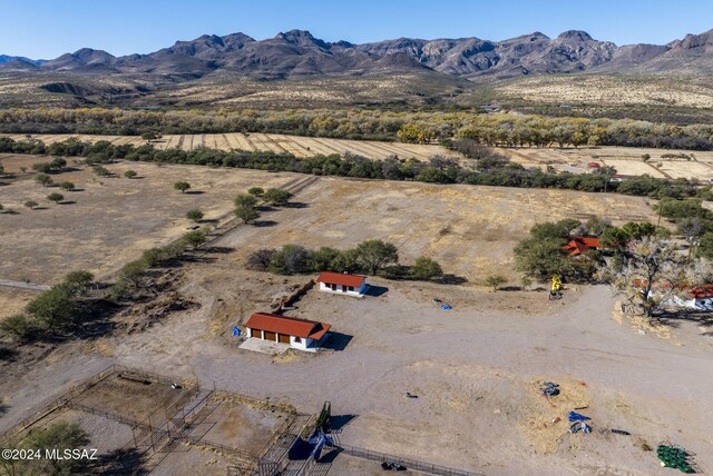 birds eye view of property featuring a mountain view and a rural view