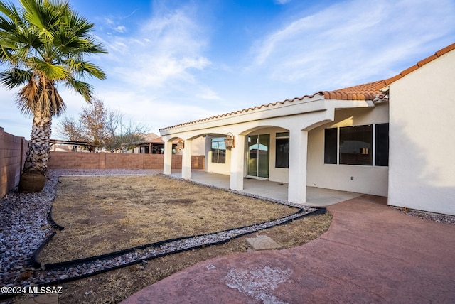 rear view of property featuring a patio area