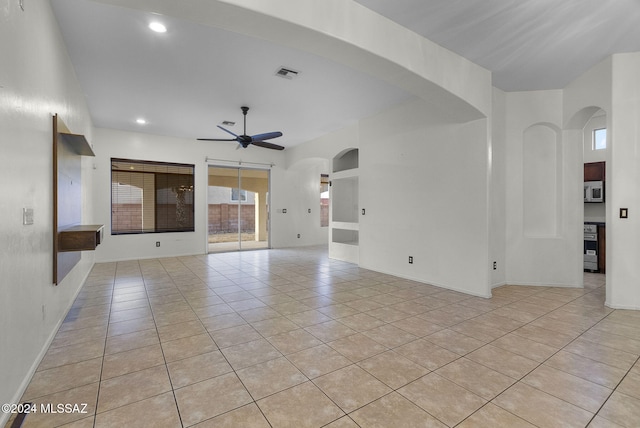 unfurnished living room featuring ceiling fan and light tile patterned flooring